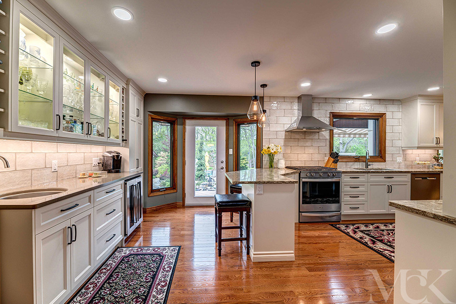Kitchen with under-cabinet lighting, stone counter tops and breakfast bar.